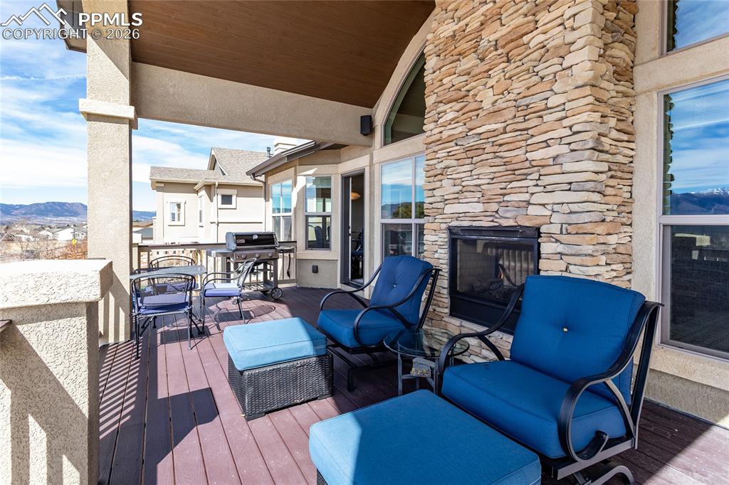 Image 20 of 50: Stay warm on the large, covered deck with double-sided gas fireplace with e