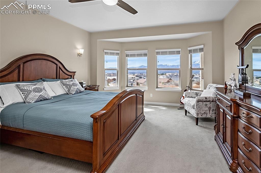 Image 22 of 50: Very spacious primary bedroom with sitting area to enjoy the Pikes Peak vie