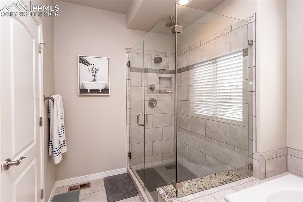 Image 26 of 50: Frameless oversized shower and private water closet