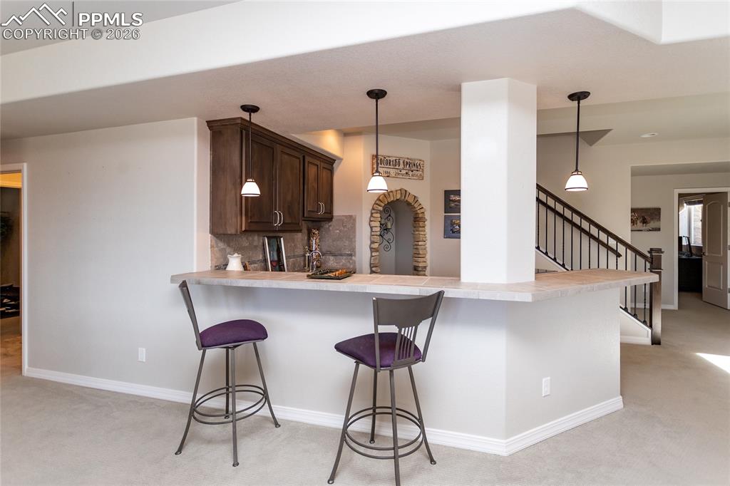 Image 32 of 50: Plenty of space to add more bar stools for entertaining