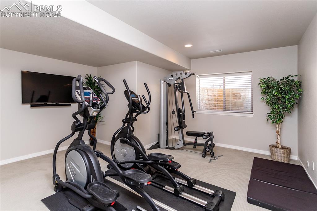 Image 39 of 50: Currently being used as a work out area, the fourth bedroom 