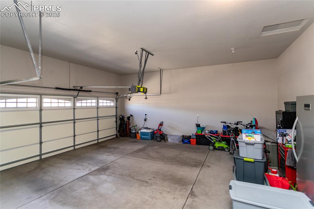 Image 43 of 50: Insulated and fully drywalled 3-car garage with taped, textured, and painte