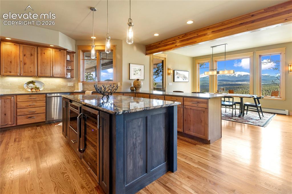 Image 10 of 36: Chef’s kitchen with custom cabinetry, granite countertops, premium applianc
