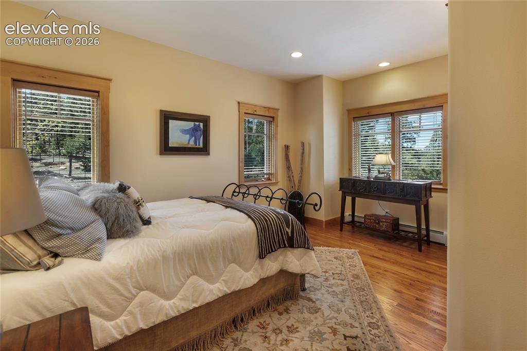 Image 16 of 36: Spacious secondary suite with large windows and tranquil mountain views!