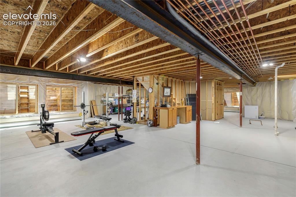 Image 29 of 36: Massive unfinished walkout basement offering exceptional storage and endles