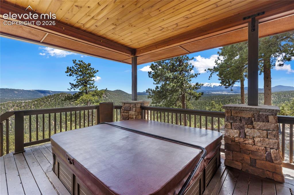 Image 32 of 36: Covered outdoor deck and panoramic views of Pikes Peak