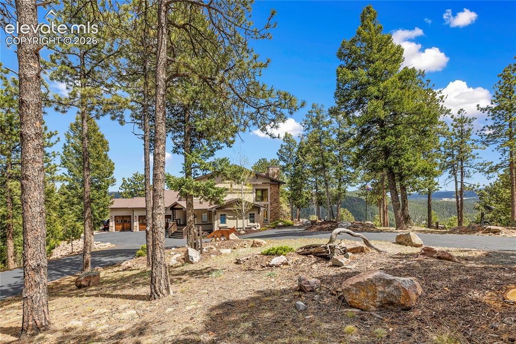 Image 34 of 36: Custom home featuring a multi-level design, attached three-car garage with