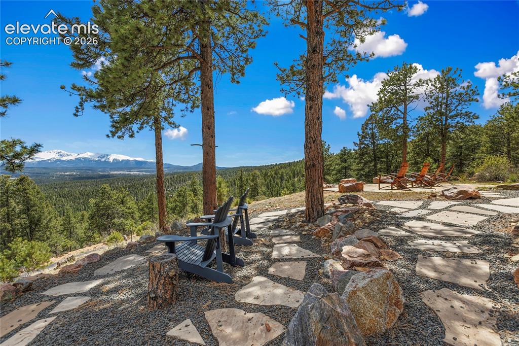 Image 36 of 36: Expansive outdoor patio featuring irregular flagstone pavers set in gravel,