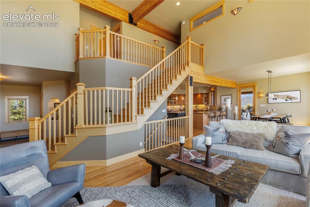 Image 6 of 36: Warm and inviting living area with vaulted ceilings, exposed beams!