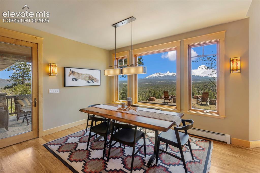 Image 7 of 36: Dining room with breathtaking views of Pikes Peak and direct access to the