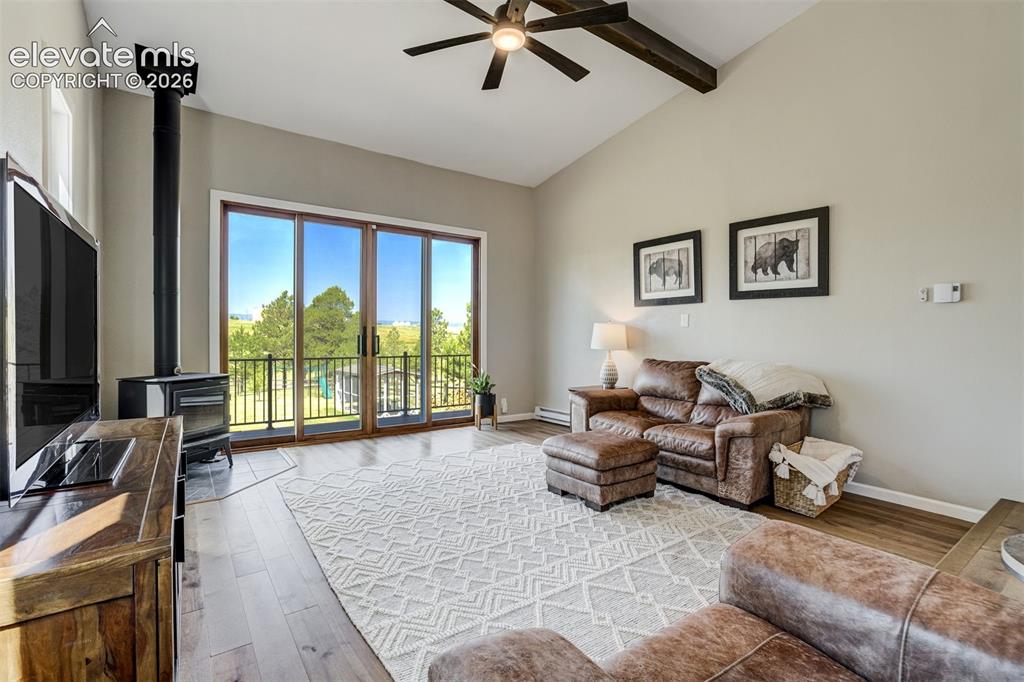 Image 11 of 50: Beamed ceiling, vaulted ceiling, walkout to deck, fireplace