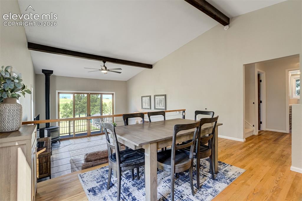 Image 13 of 50: Vaulted ceilings with exposed beams complement the open-concept living spac