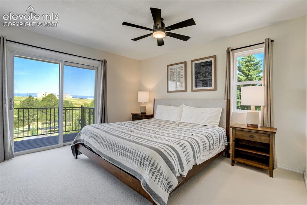 Image 19 of 50: Virtually Staged Primary Bedroom featuring a private balcony, sliding glass