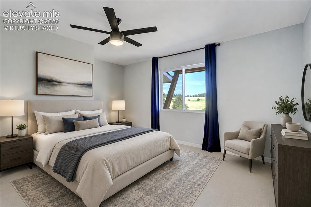 Image 30 of 50: Main level bedroom featuring light gray walls and white trim