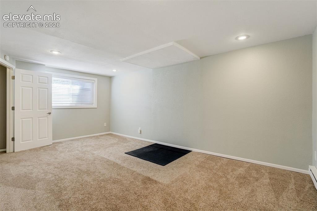 Image 35 of 50: Virtually Staged Recessed lighting illuminates this living space featuring