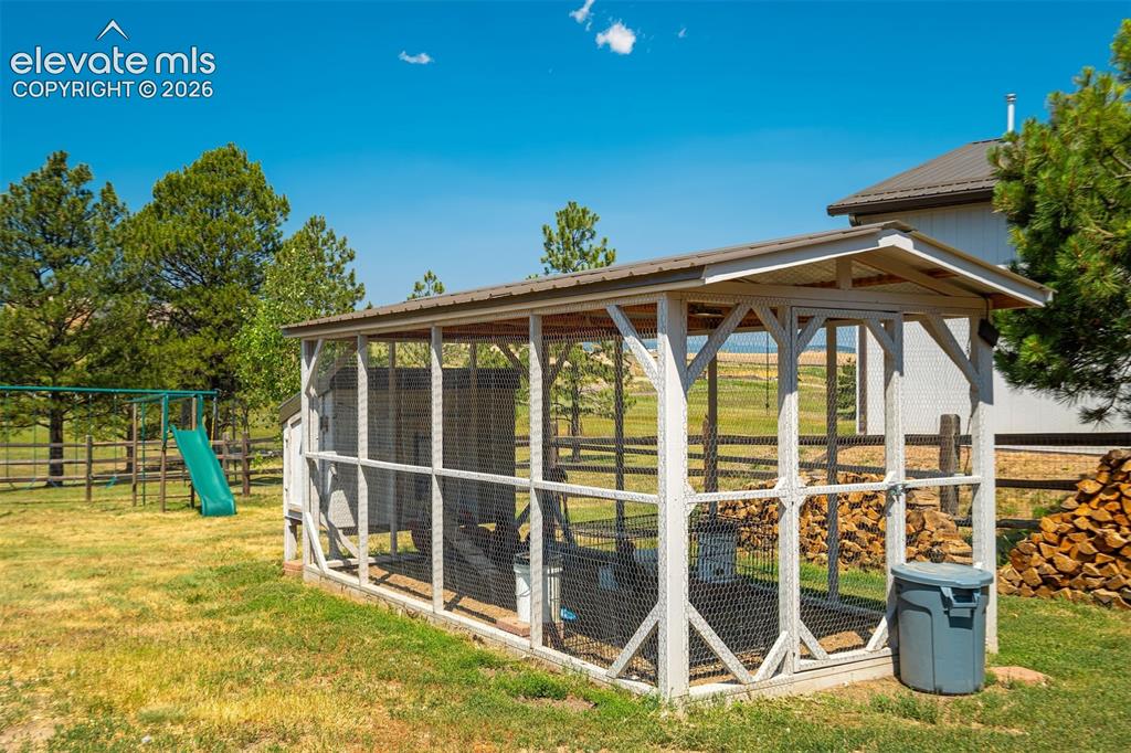 Image 43 of 50: Expansive outdoor space featuring a fenced area, detached shed, workshop, h
