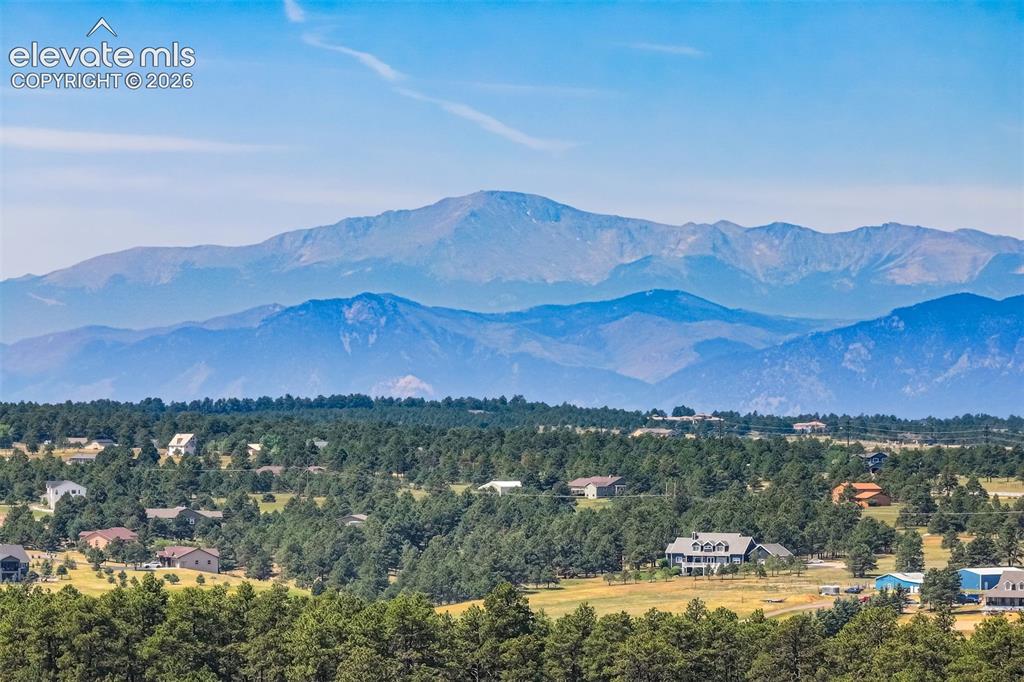 Image 6 of 50: Expansive rural property featuring a main residence, a detached garage/outb