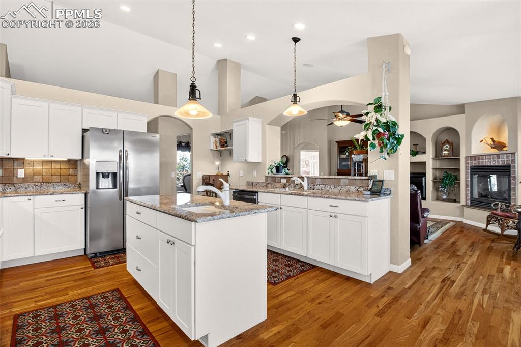 Image 10 of 49: Open Kitchen, Island With Prep Sink And Granite Counters.