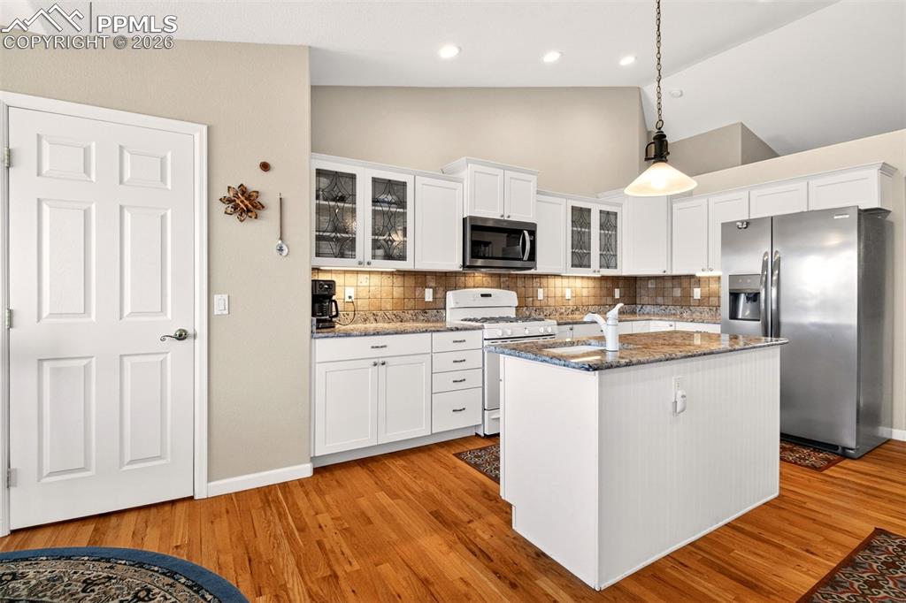 Image 12 of 49: Large Pantry, Gas Stove, Tile Backsplash.