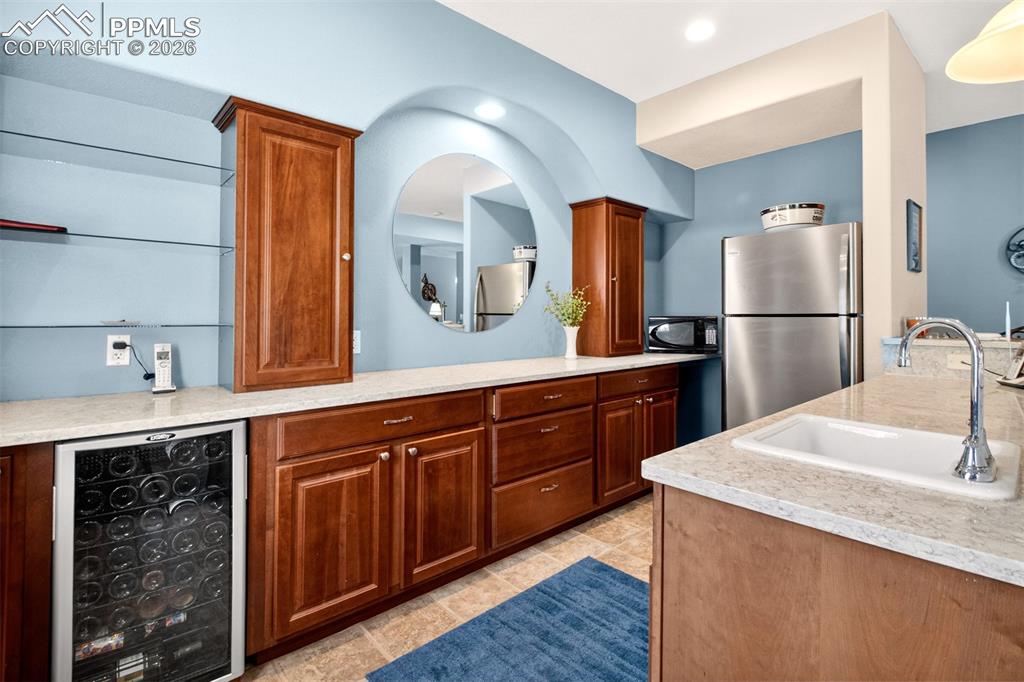 Image 32 of 49: Wet Bar, Mini Fridge Included.