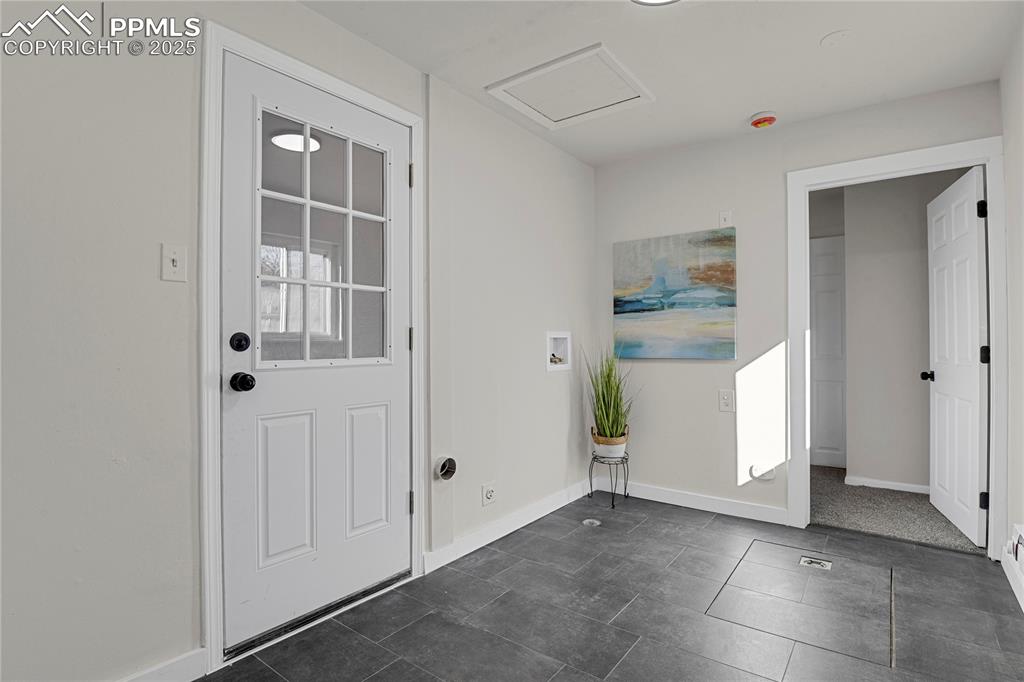 Image 20 of 24: Generously sized laundry room with walk-out to back yard.