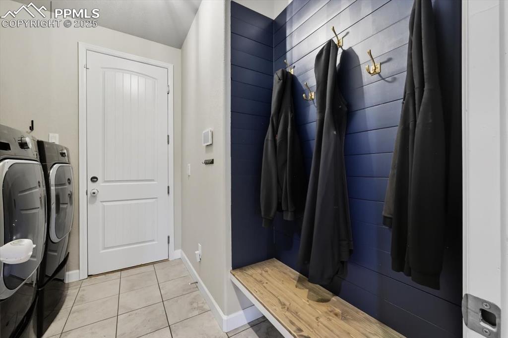 Image 19 of 47: Mudroom with light tile patterned flooring and washer and dryer