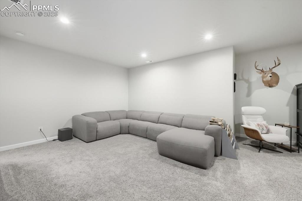 Image 30 of 47: Carpeted living room with recessed lighting and baseboards