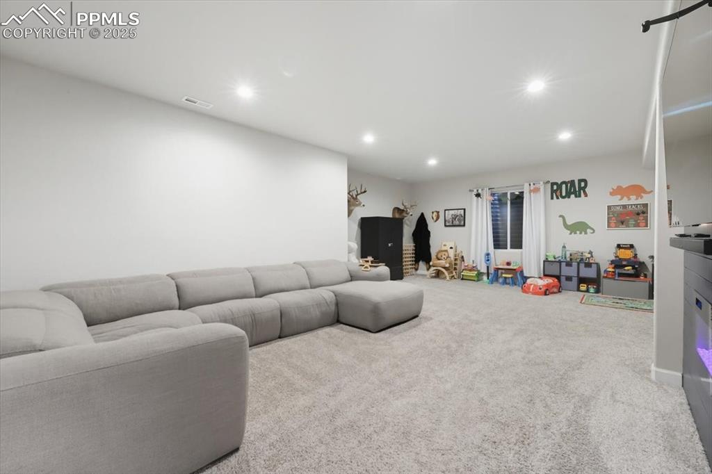 Image 32 of 47: Carpeted living room featuring recessed lighting