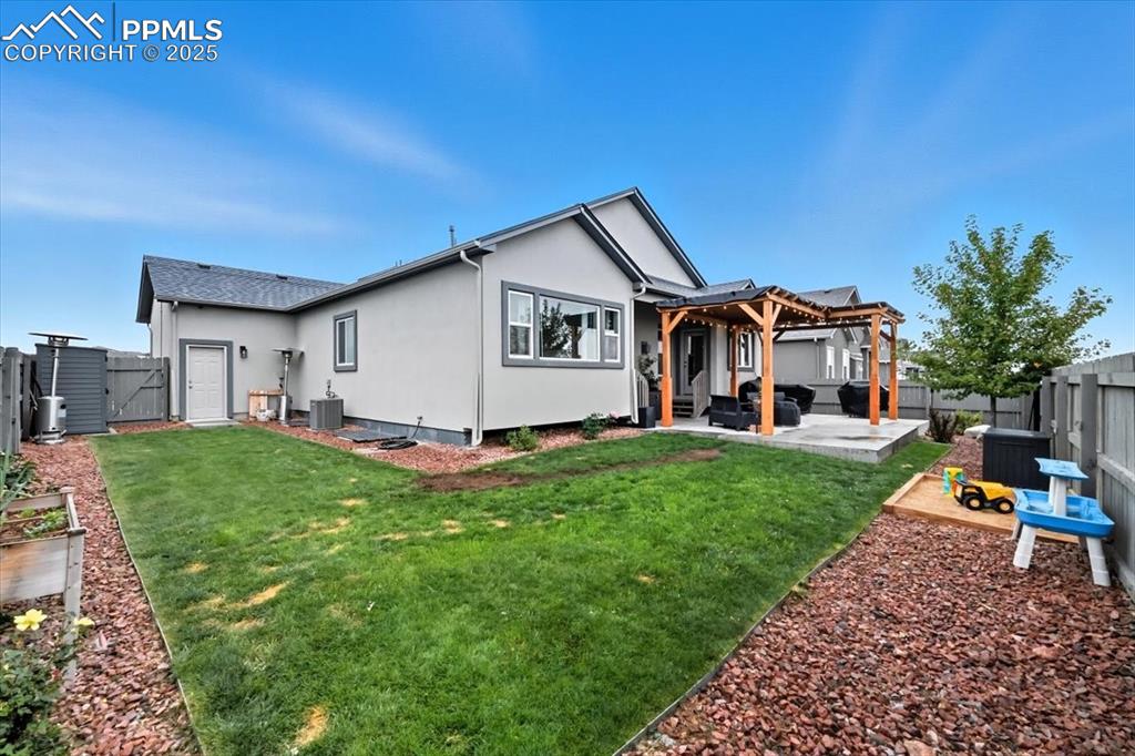 Image 42 of 47: Rear view of property featuring a fenced backyard, a patio area, stucco sid