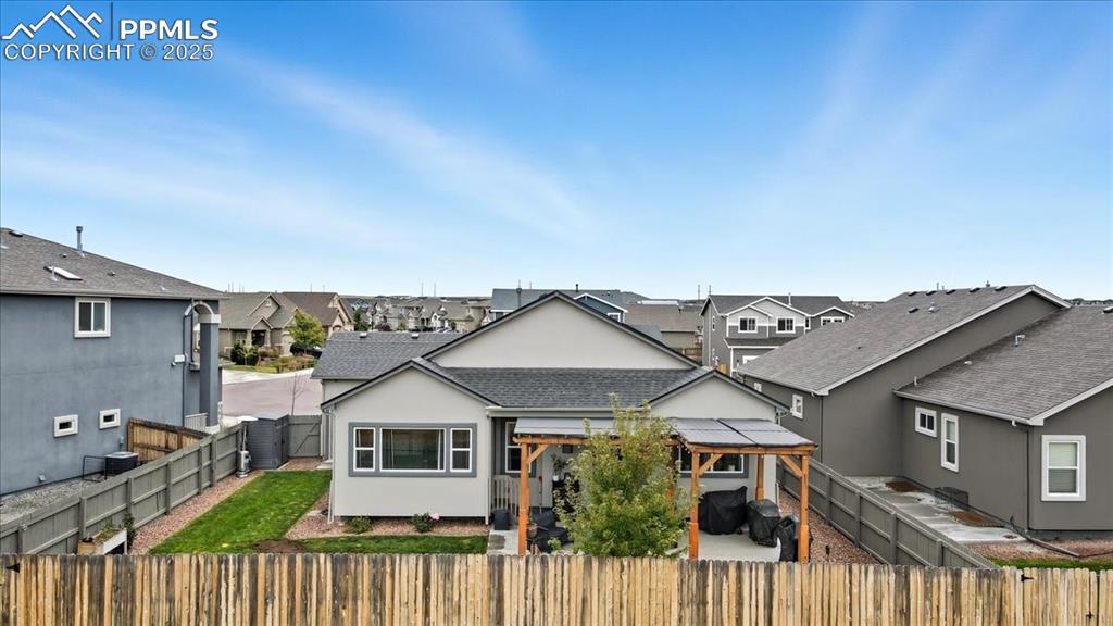 Image 43 of 47: View of front of house featuring a patio area, stucco siding, a fenced back