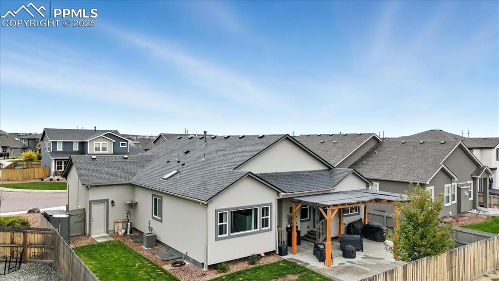 Image 44 of 47: Back of property with a fenced backyard, a patio area, stucco siding, and a