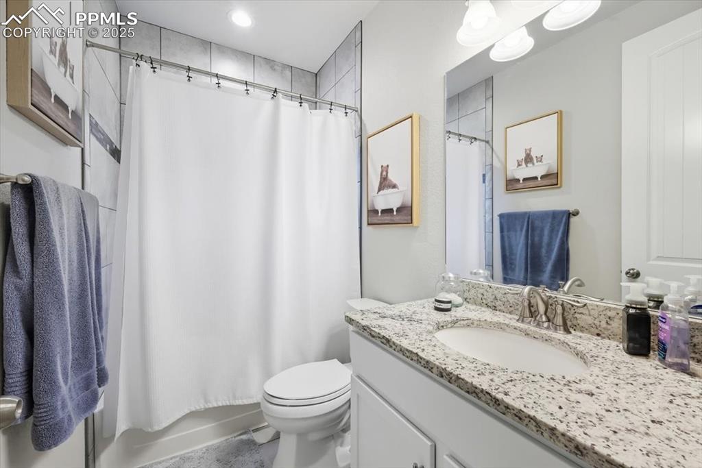 Image 7 of 47: Upstairs Full bath featuring vanity and shower / tub combo