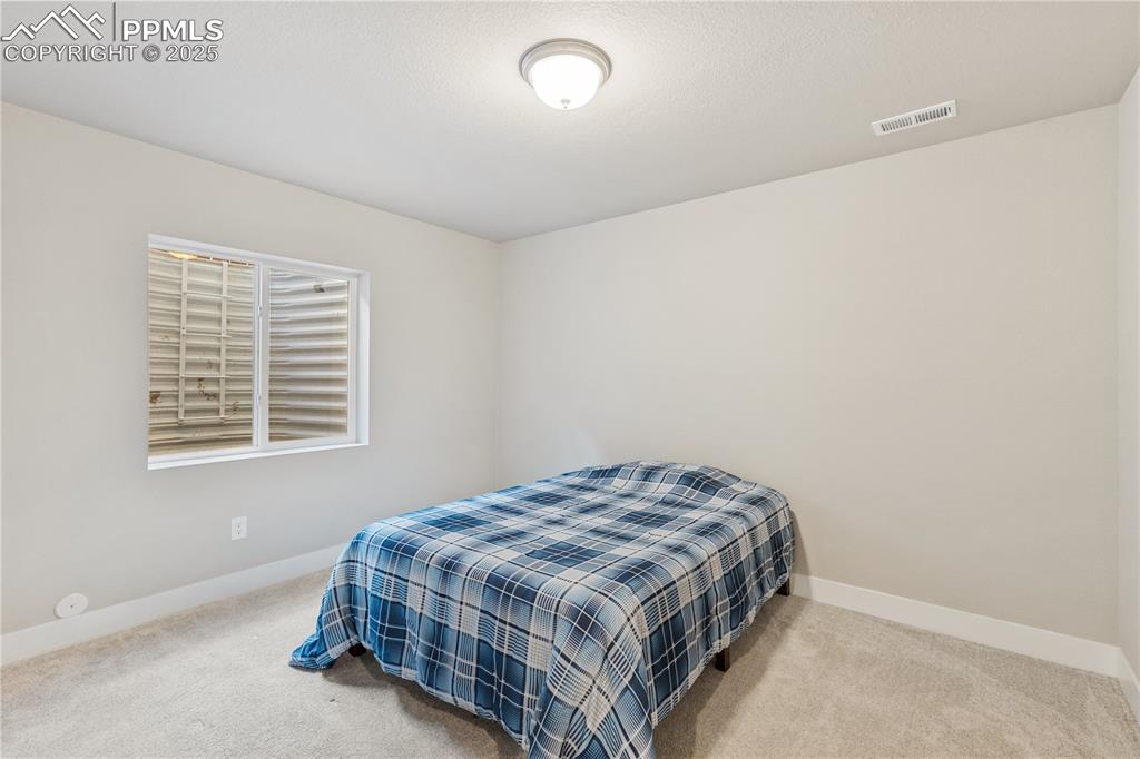 Image 36 of 46: Carpeted bedroom featuring baseboards