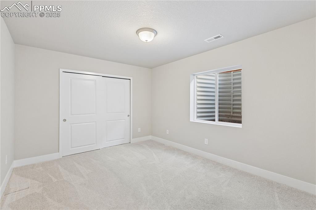 Image 39 of 46: Unfurnished bedroom featuring light carpet and a closet