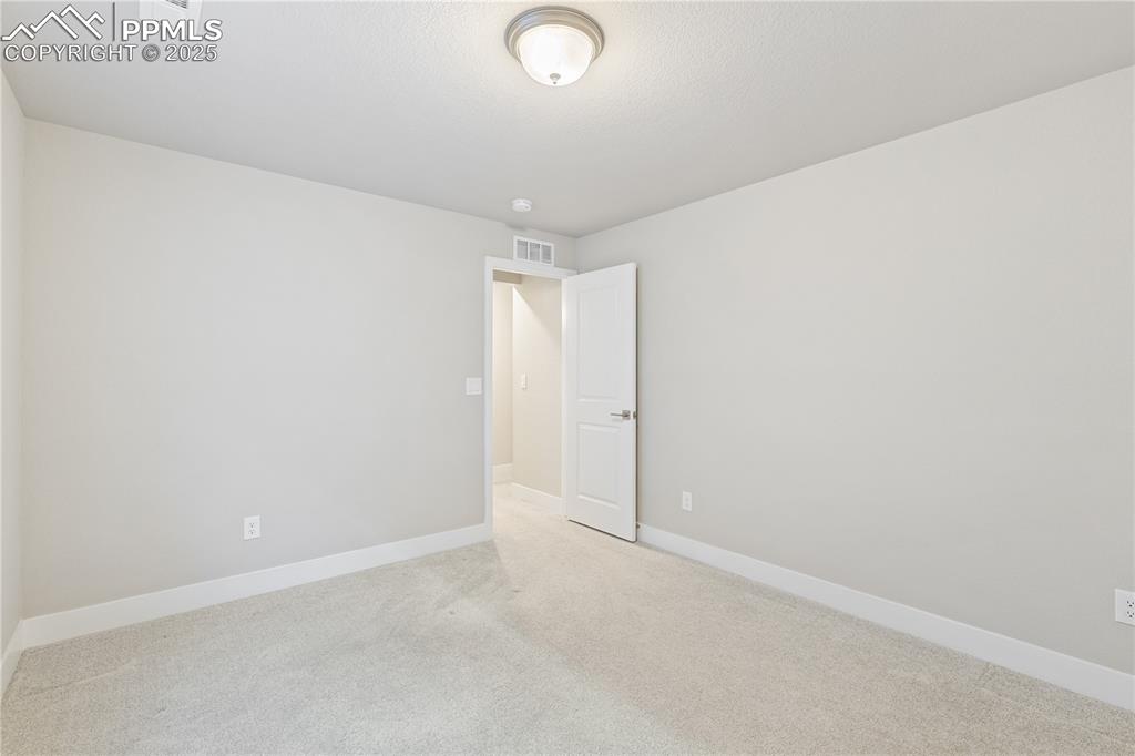 Image 40 of 46: Carpeted spare room with baseboards