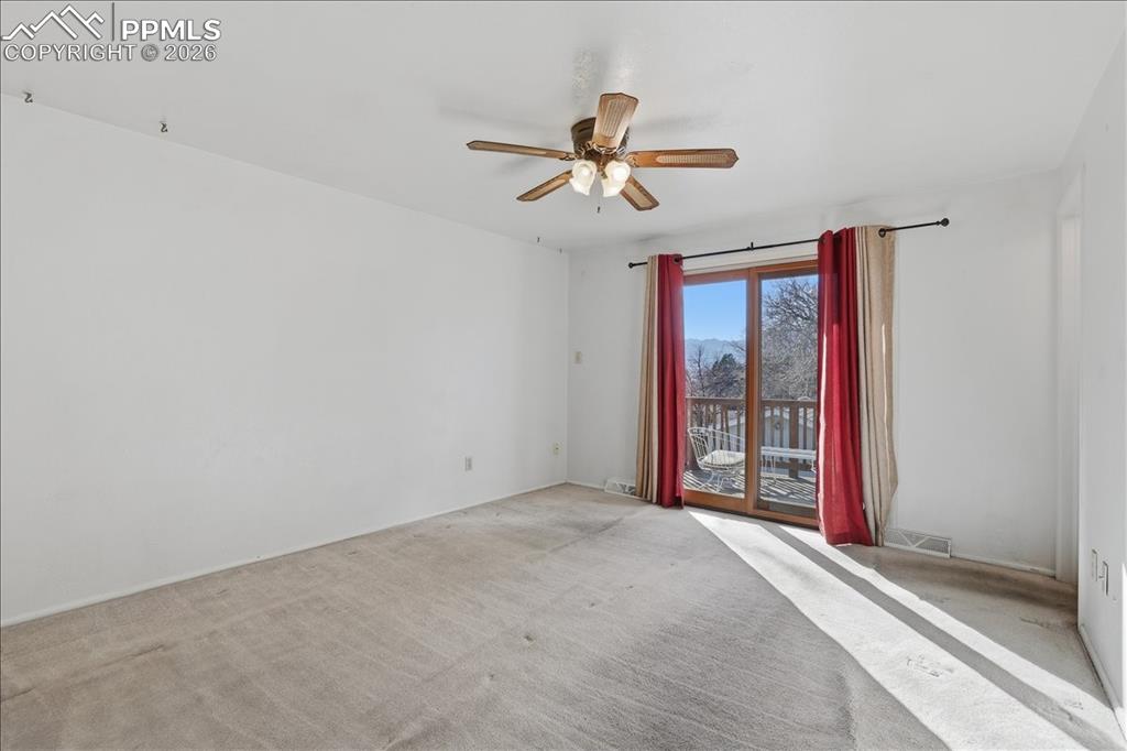 Image 10 of 28: Primary bedroom walks out to upper patio