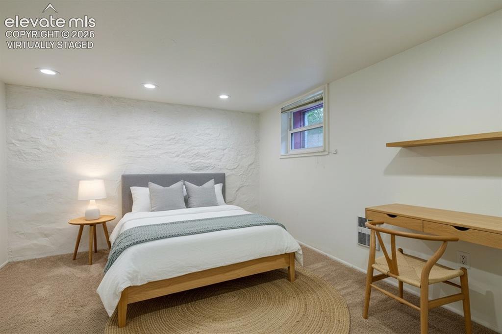 Image 32 of 50: lower level bedroom, virtually staged