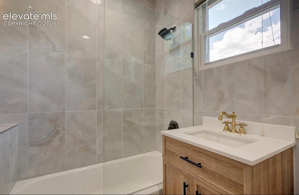 Image 5 of 50: Upper level unit, modern remodeled bathroom