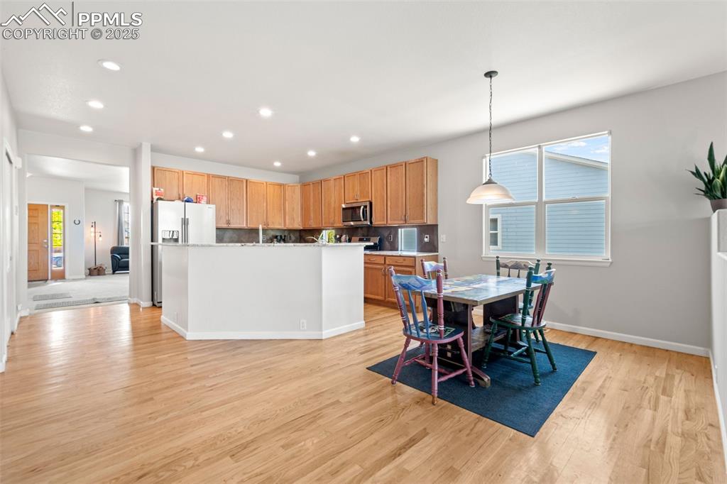 Image 13 of 39: Dining area with light wood-type flooring and recessed lighting
