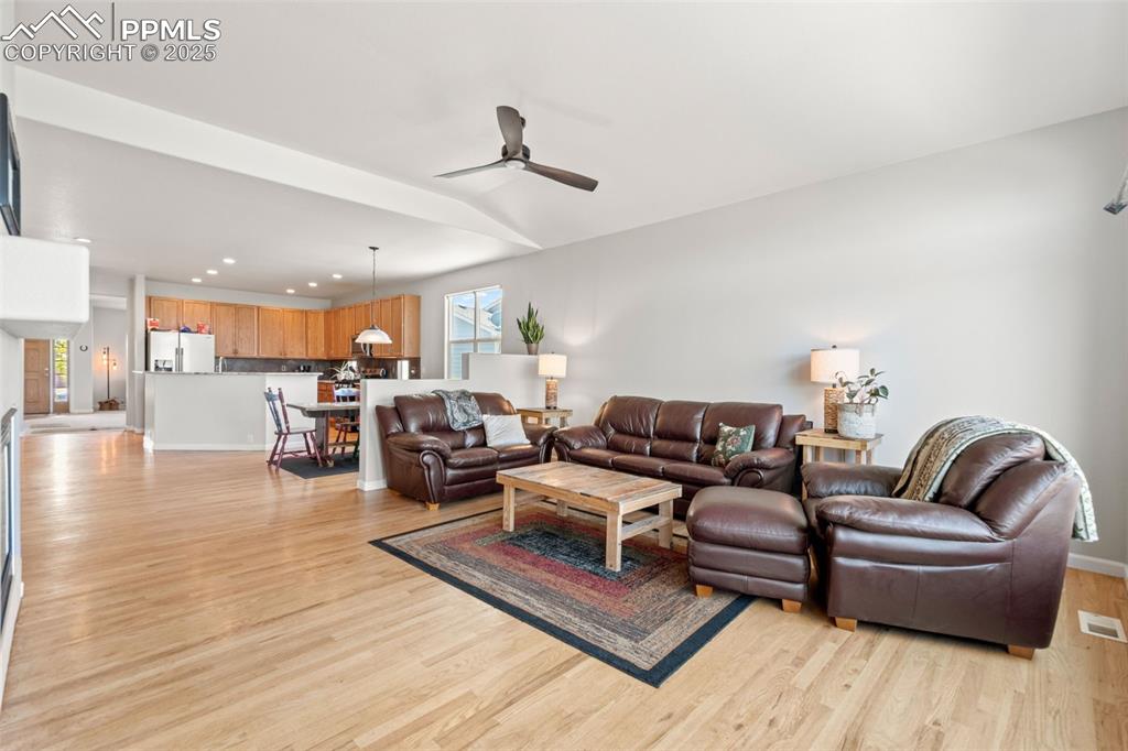 Image 16 of 39: Living area featuring ceiling fan, light wood-style flooring, recessed ligh