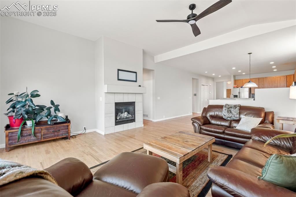Image 17 of 39: Living area featuring light wood-type flooring, a ceiling fan, recessed lig