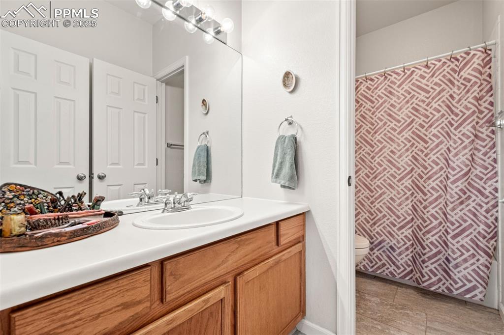 Image 25 of 39: Full bathroom with vanity and a shower with shower curtain