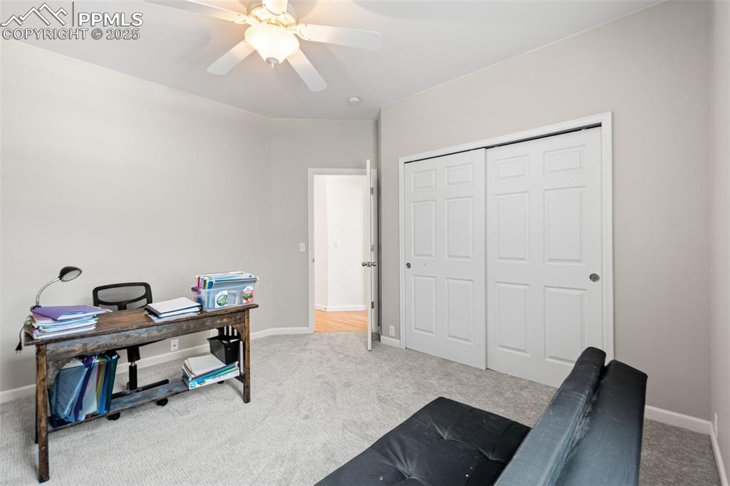 Image 28 of 39: Home office featuring light carpet and ceiling fan