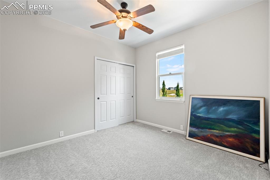 Image 29 of 39: Unfurnished bedroom featuring carpet floors, ceiling fan, and a closet