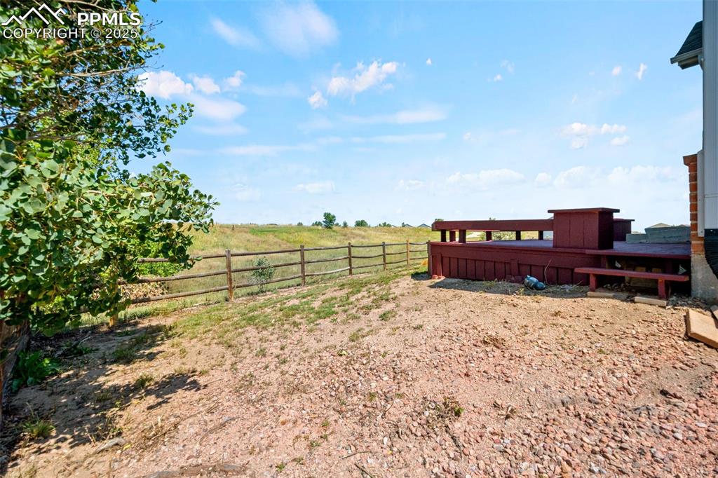 Image 33 of 39: View of yard with a view of rural / pastoral area and a wooden deck