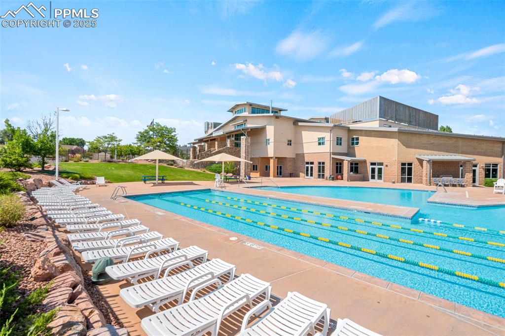Image 36 of 39: Community pool featuring a patio area and a yard