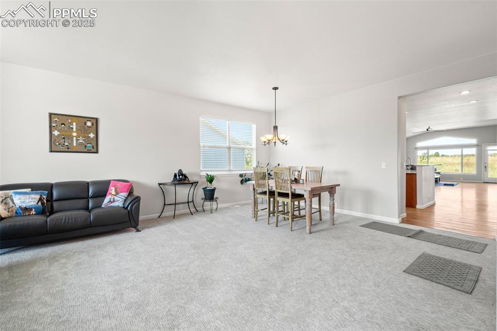 Image 4 of 39: Dining space featuring carpet and a chandelier