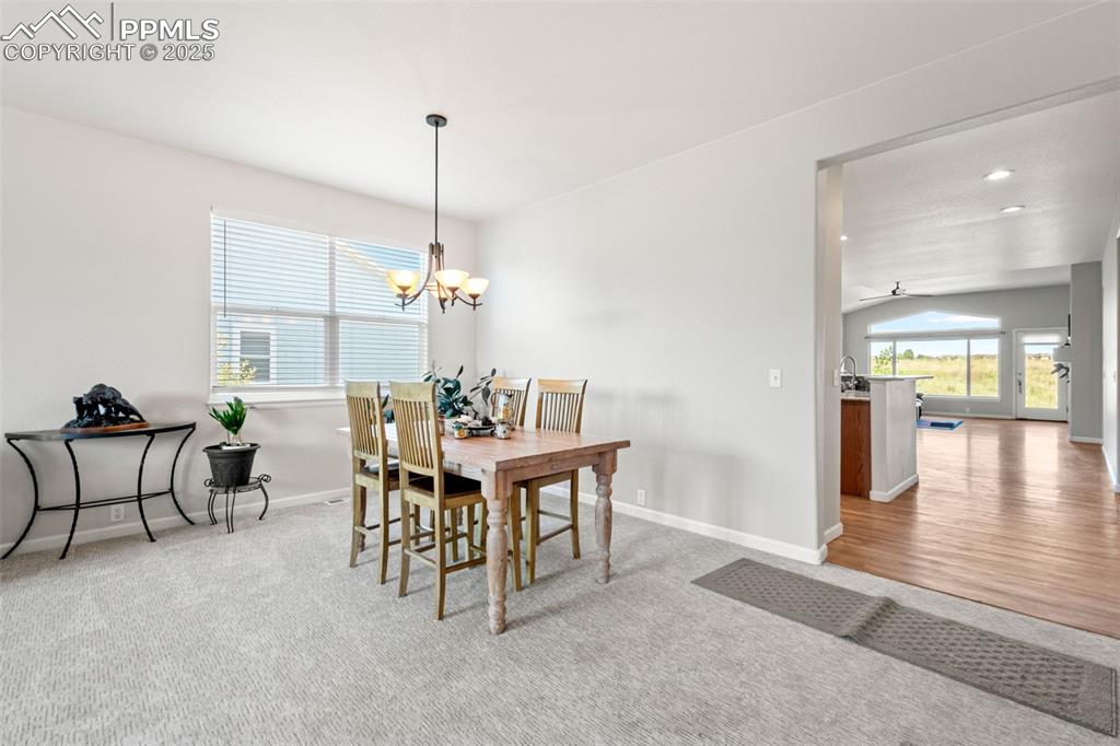 Image 5 of 39: Dining room featuring light colored carpet, a chandelier, and recessed ligh