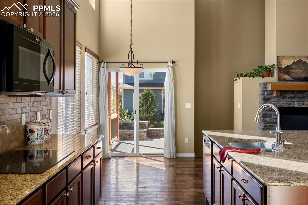 Image 10 of 43: Kitchen walks out to back patios and yard. 