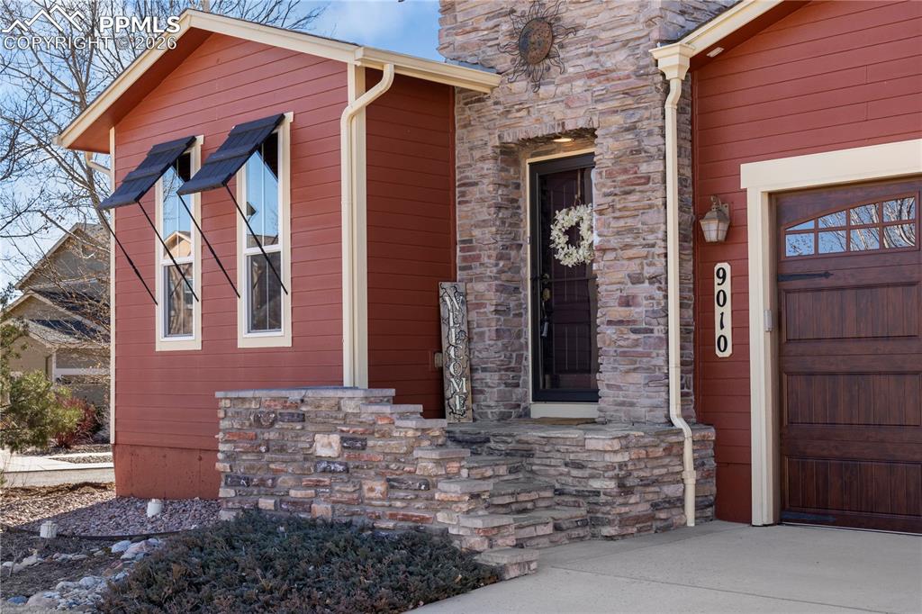 Image 2 of 43: Welcoming front porch with beautiful stacked stone accents. 